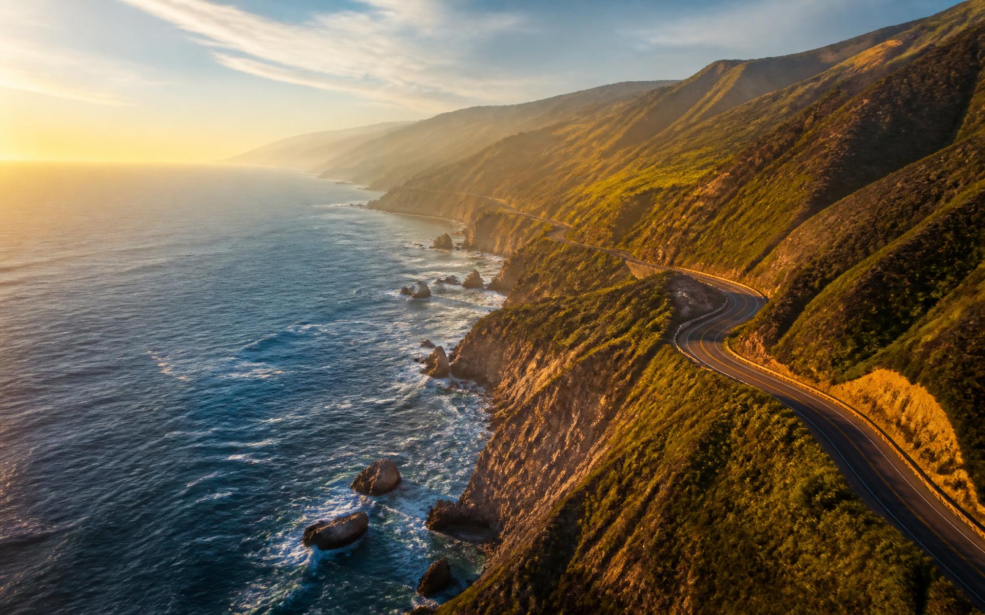 Winding coastal highway along dramatic sea cliffs at golden hour